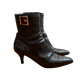 Black Prada boots featuring a buckle and pointy toe