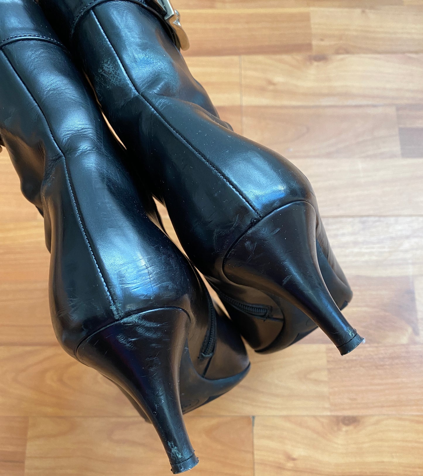 Black Prada boots featuring a buckle and pointy toe